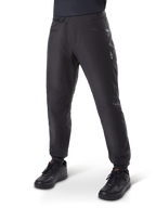 Alpinestars A-Dura Waterproof Pants, MTB Cycling Pants, Black, featuring a ratchet waist closure, zippered pockets, and a white Astars logo on the thigh, shown worn with black cycling shoes for all-weather trail riding