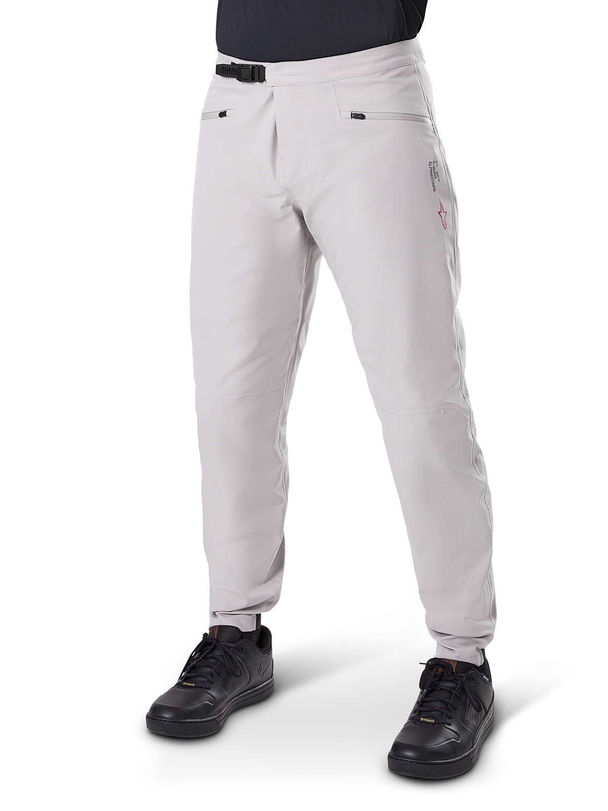 Alpinestars A-Dura Waterproof Pants, Mountain Bike Pants, Titanium Gray, featuring a black ratchet waist closure and zippered hand pockets, tapered legs with elastic cuffs, worn with black shoes, durable 3L waterproof construction for off-road cycling