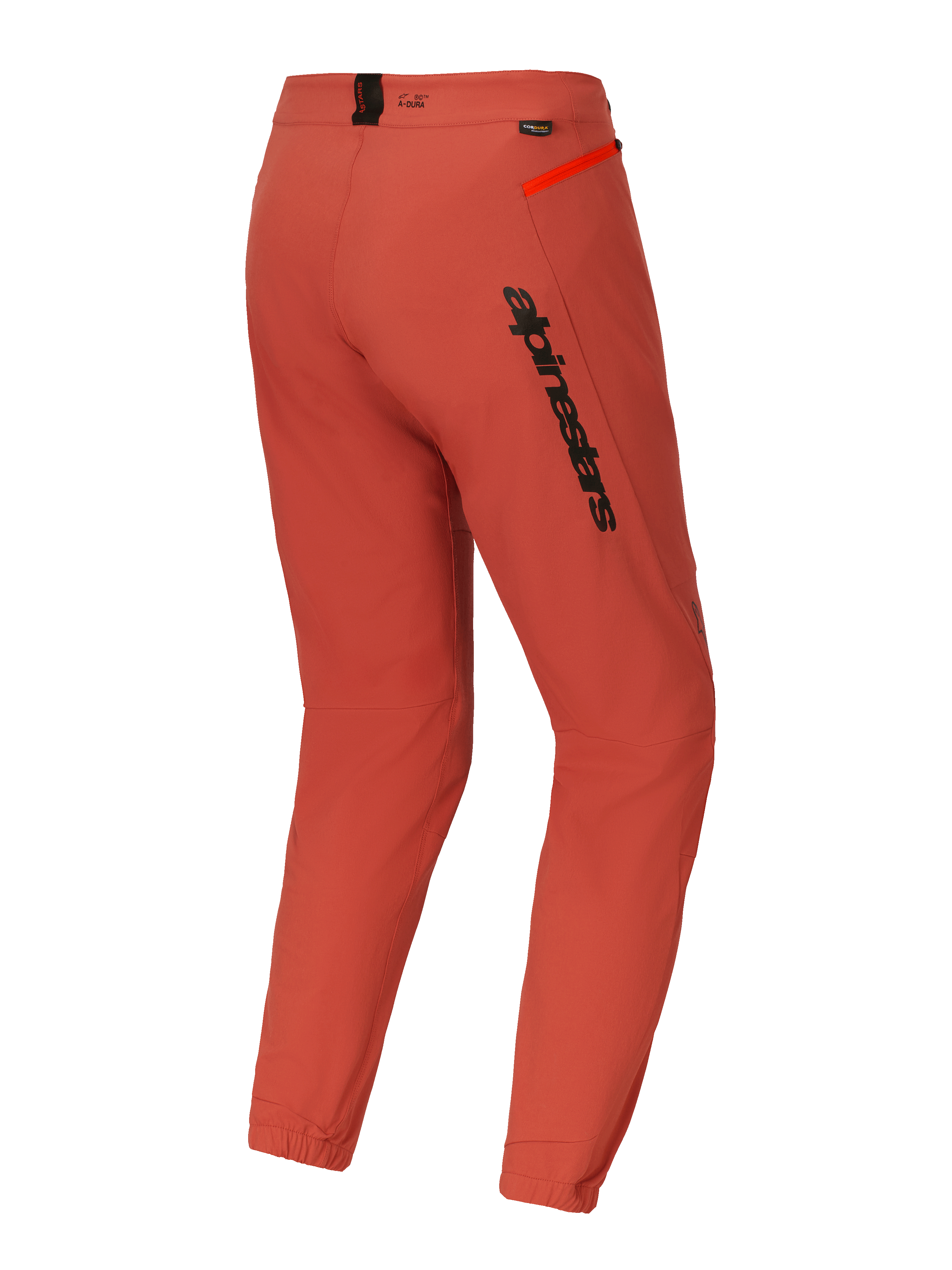 Spodnie Alpinestars A-Dura Elite, spodnie na rower górski (MTB), ciemnopomarańczowe, widok z tyłu pod kątem trzech czwartych, wyraźne czarne logo Alpinestars na udzie, jaskrawopomarańczowy akcent zamka na biodrze, elastyczne ściągacze w kostkach, techniczna odzież rowerowa
