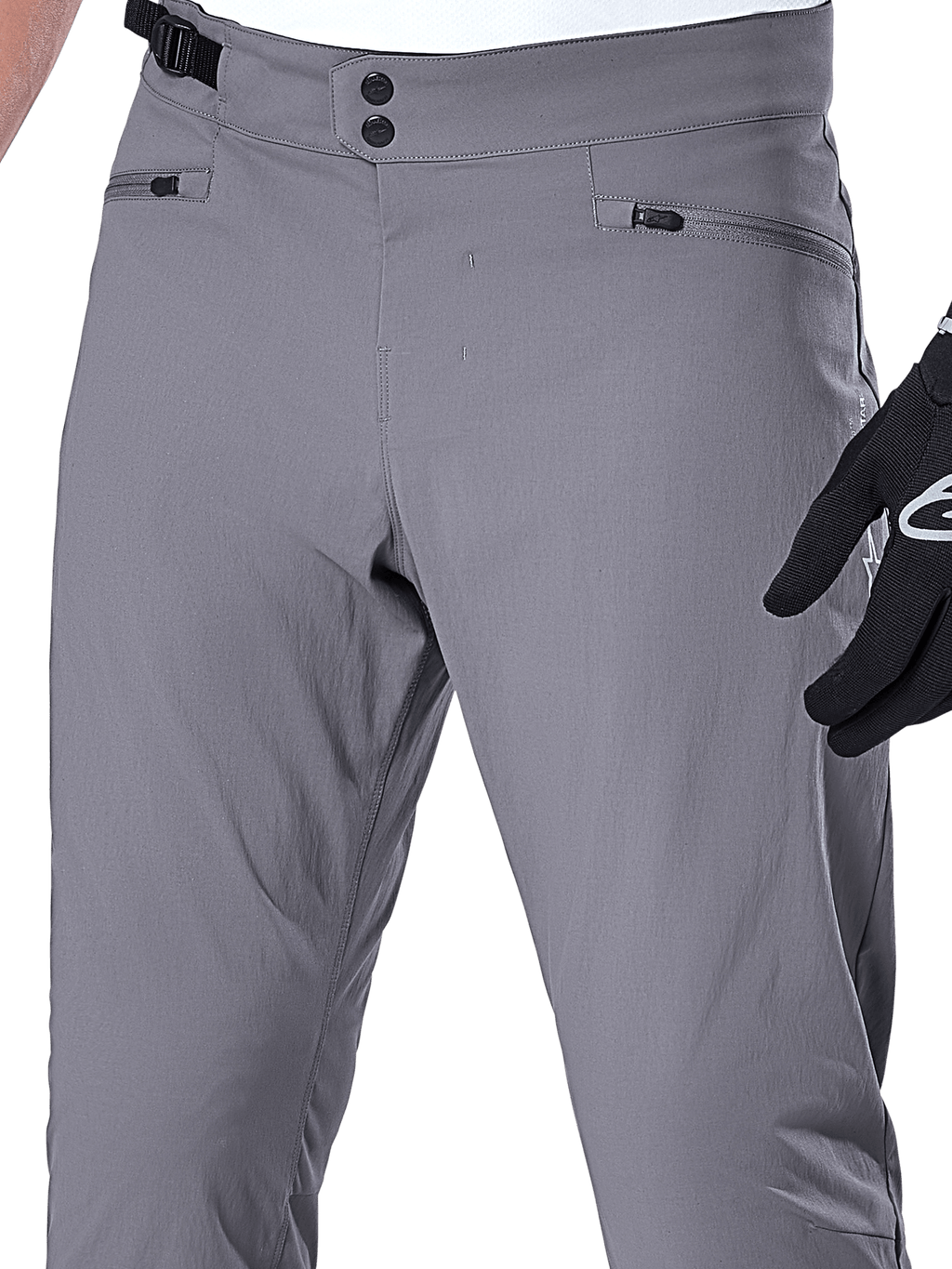 Alpinestars A-Dura Pants, spodnie MTB, ciemnoszare, zbliżenie na obszar talii z podwójnym zapięciem na zatrzaski, boczną regulacją i kieszeniami zapinanymi na zamek, wytrzymały elastyczny materiał do kolarstwa górskiego