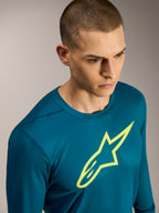 Koszulka Alpinestars A-Dura Ride z długim rękawem, morski top MTB z żółtym logo Astars i elastyczny materiał techniczny.