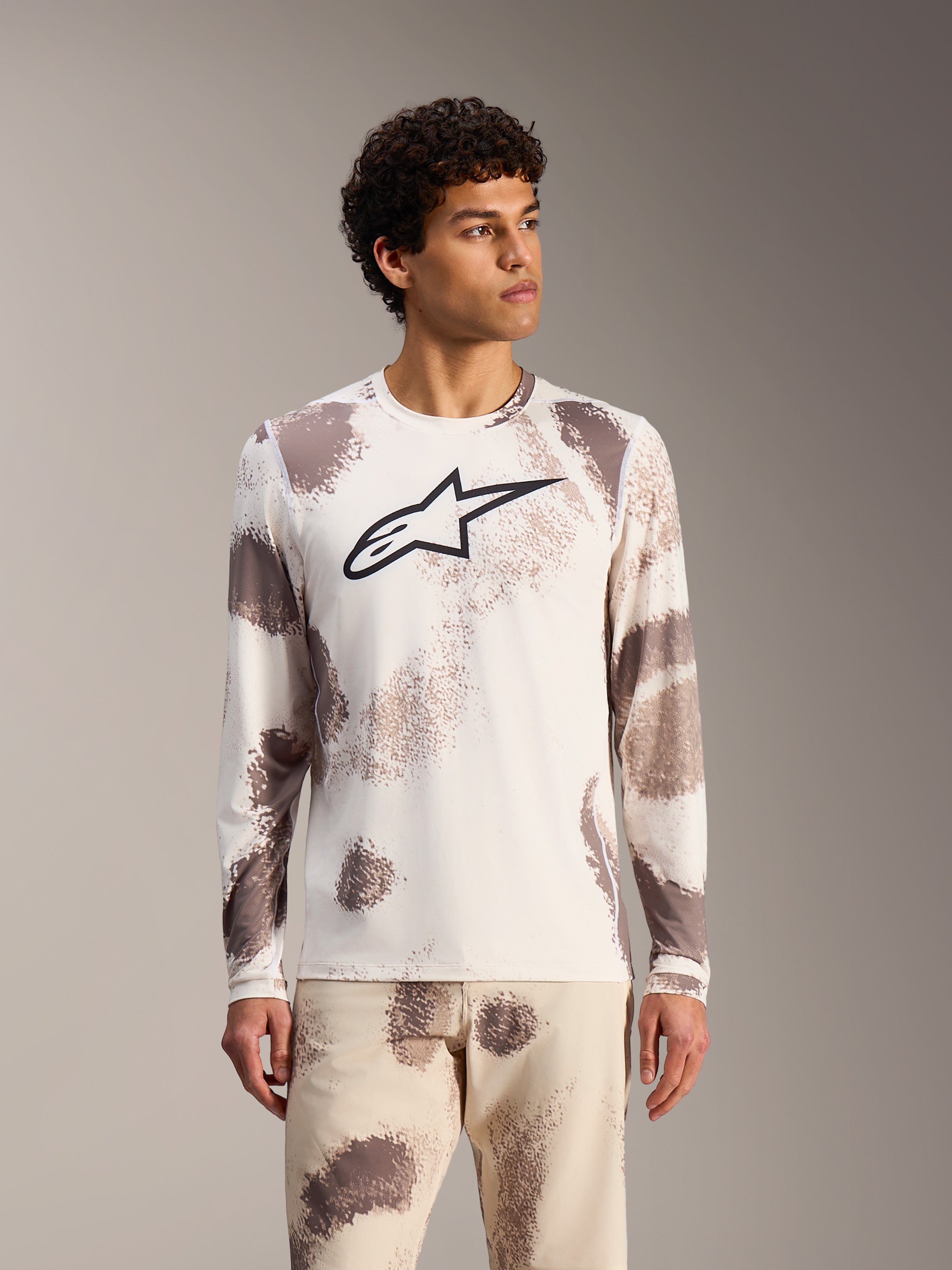 Koszulka Alpinestars A-Dura Ride Long Sleeve, kolor Sand Camo, biały top MTB w abstrakcyjne wzory z czarnym logo.
