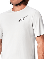 Alpinestars A-Aria Astar Jersey, koszulka rowerowa z krótkim rękawem, kolor White Dove, zbliżenie na czarne logo Astar na piersi, oddychający teksturowany materiał poliestrowy, lekki sportowy krój do jazdy MTB