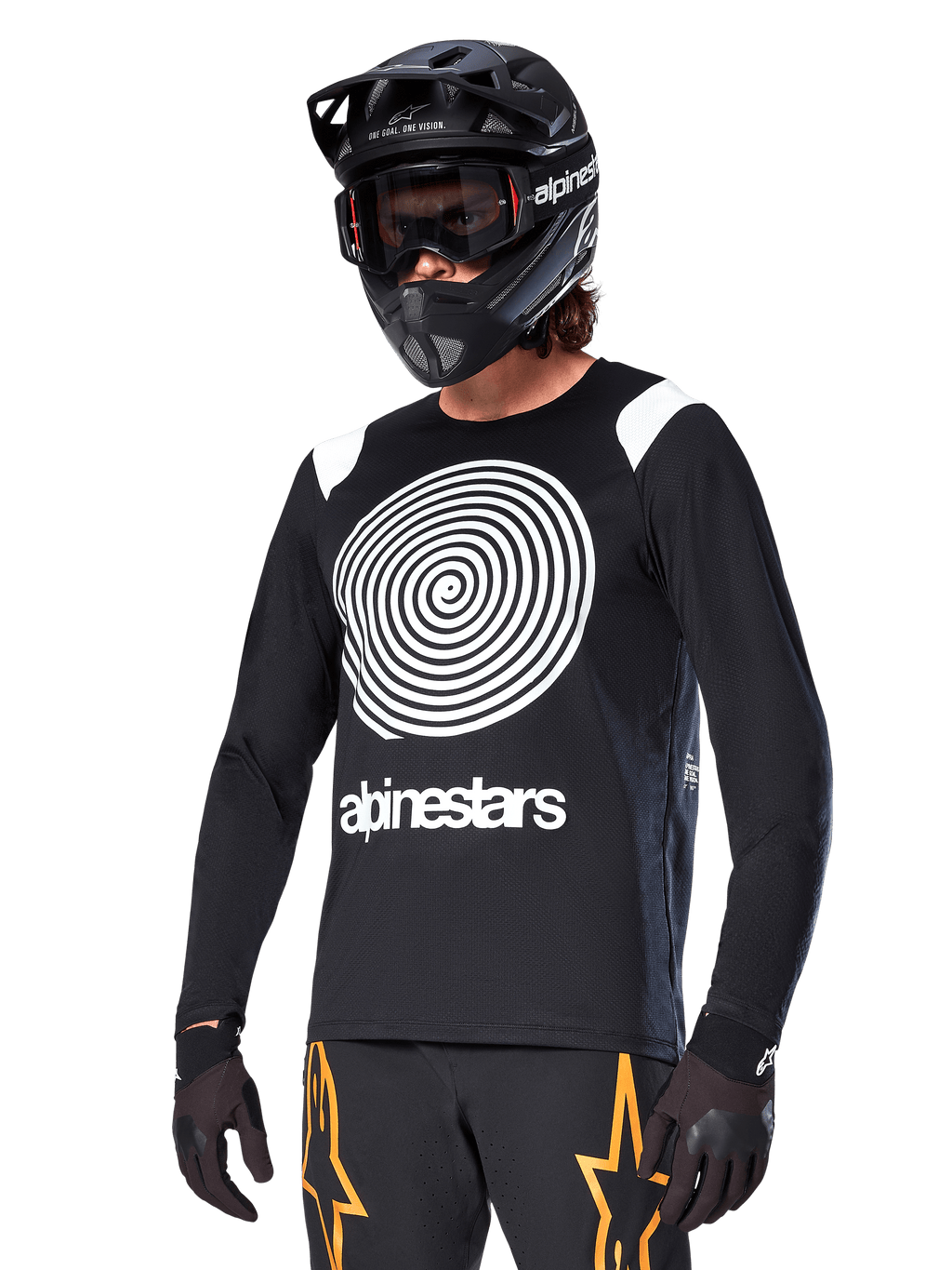 Alpinestars A-Supra Oscar Long Sleeve Jersey, koszulka rowerowa MTB, czarno-biała, z wyrazistym białym spiralnym wzorem i logo Alpinestars na klatce piersiowej, noszona z czarnym kaskiem full-face i goglami, profesjonalna odzież do kolarstwa górskiego