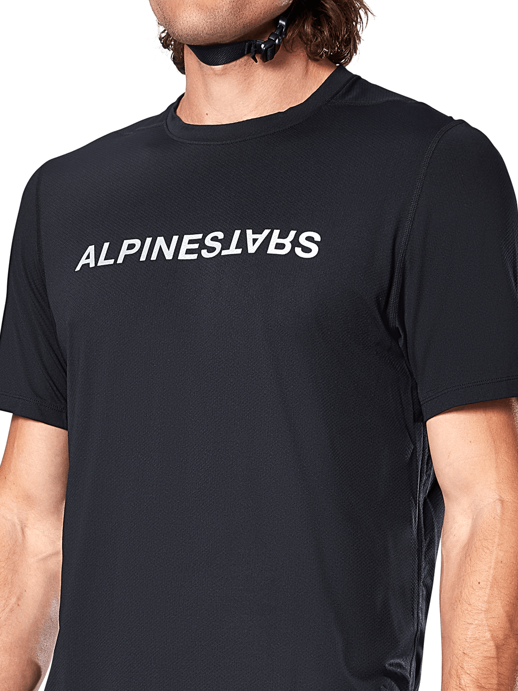 Alpinestars A-Dura Switch Short Sleeve Jersey, czarna koszulka z krótkim rękawem, duże białe logo nadrukowane na klatce piersiowej, tekstura materiału żakardowego, zbliżenie z przodu