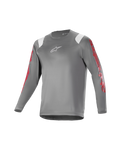 Alpinestars Youth A Supra Astar Long Sleeve Jersey, młodzieżowa koszulka z długim rękawem, ciemnoszara z białymi akcentami na ramionach i czerwonymi oznaczeniami na rękawach, białe logo na klatce piersiowej, oddychający materiał techniczny, okrągły dekolt, sportowy krój do jazdy na rowerze górskim