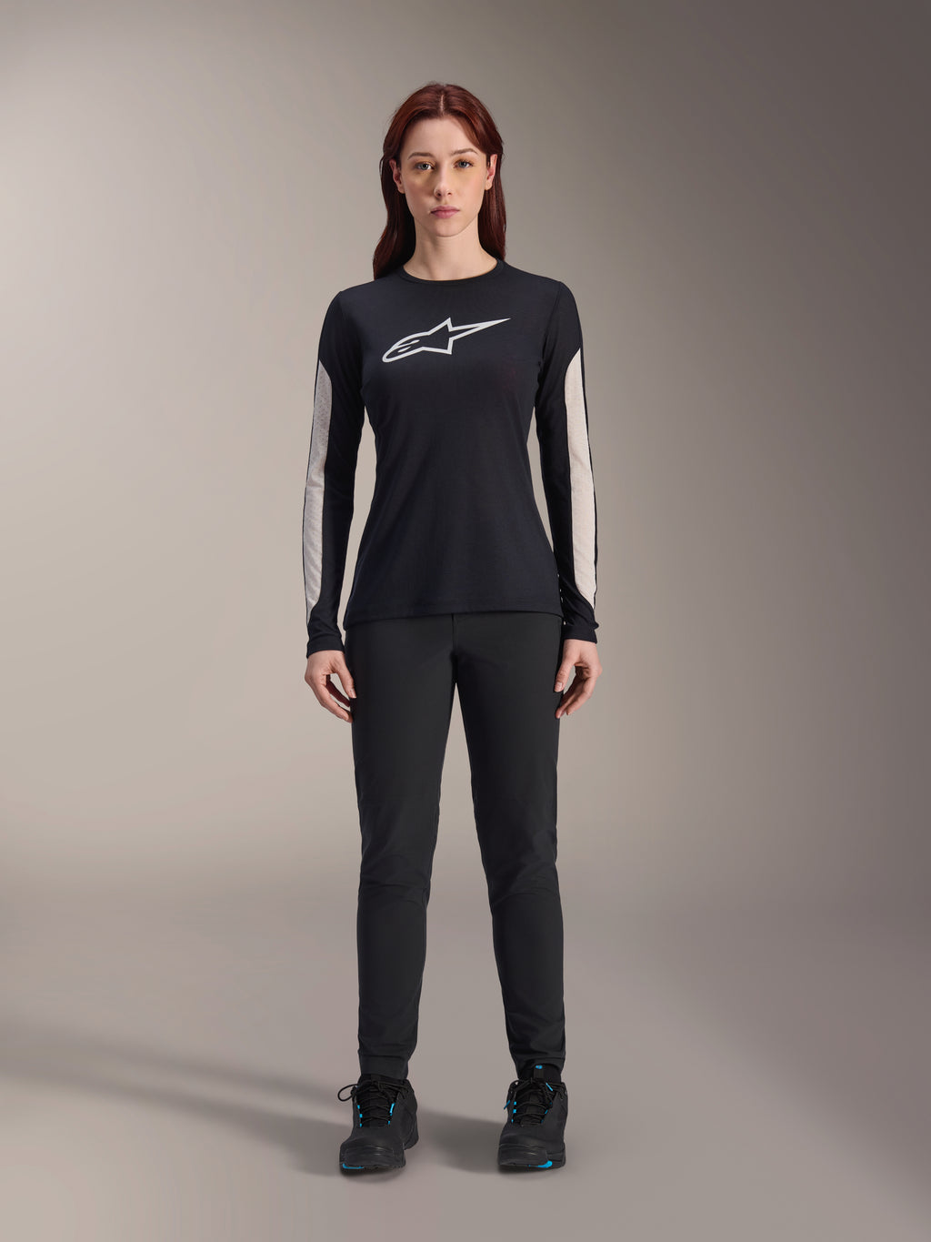 Damskie spodnie Alpinestars Stella A-Dura, czarne spodnie MTB, dedykowany damski krój i opływowy design, w zestawieniu z czarną koszulką z długim rękawem i czarnymi butami rowerowymi, wytrzymała odzież do jazdy terenowej na rowerze górskim