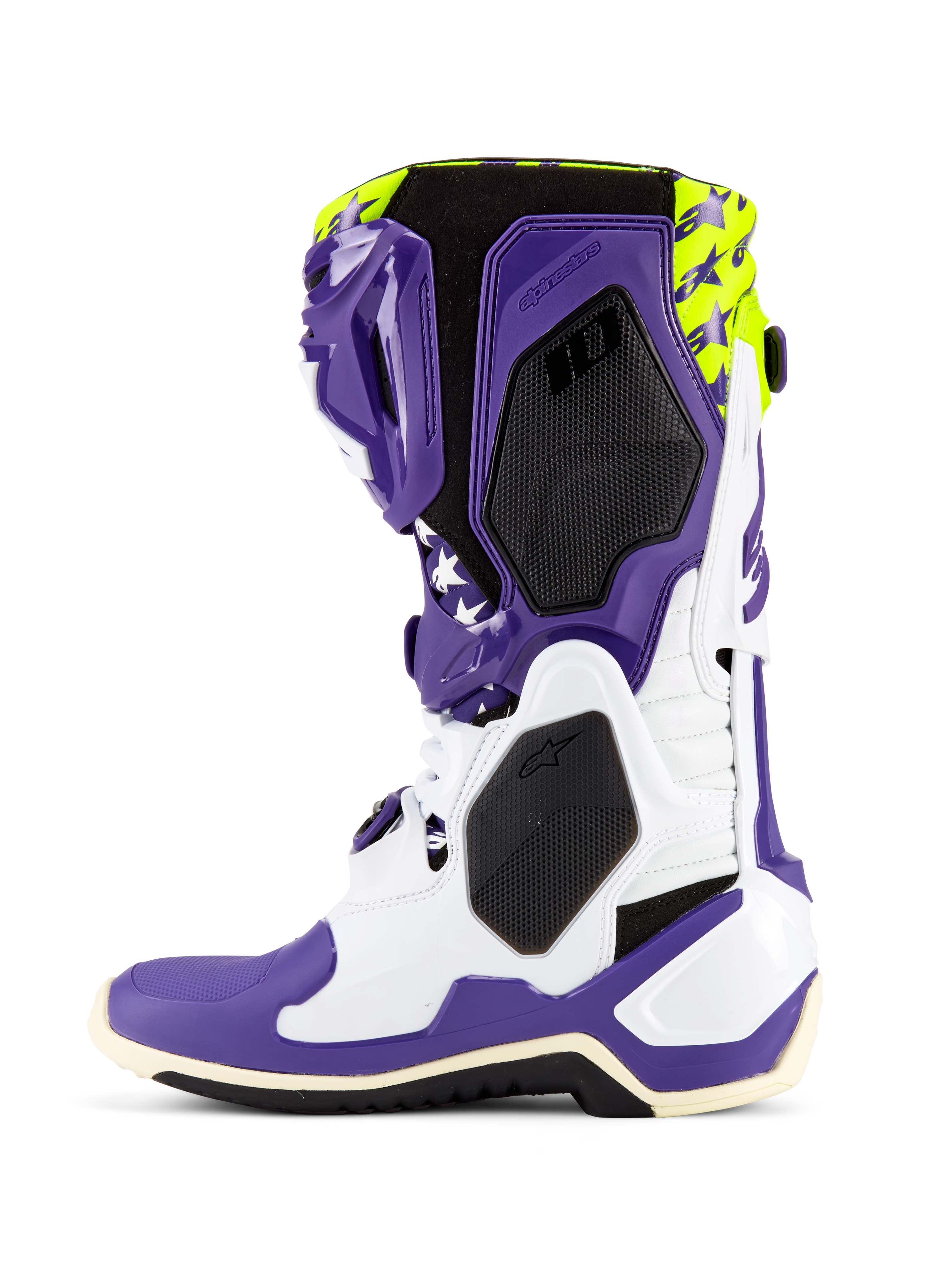 Buty Alpinestars Tech 10 Dirt Studios® LE, buty motocrossowe, białe, fioletowe i żółte neonowe, widok z boku prezentujący biało-fioletowy szkielet TPU, neonowo żółtą górę z grafikami gwiazd, czarne panele o teksturze plastra miodu oraz profesjonalny design wyścigowy off-road
