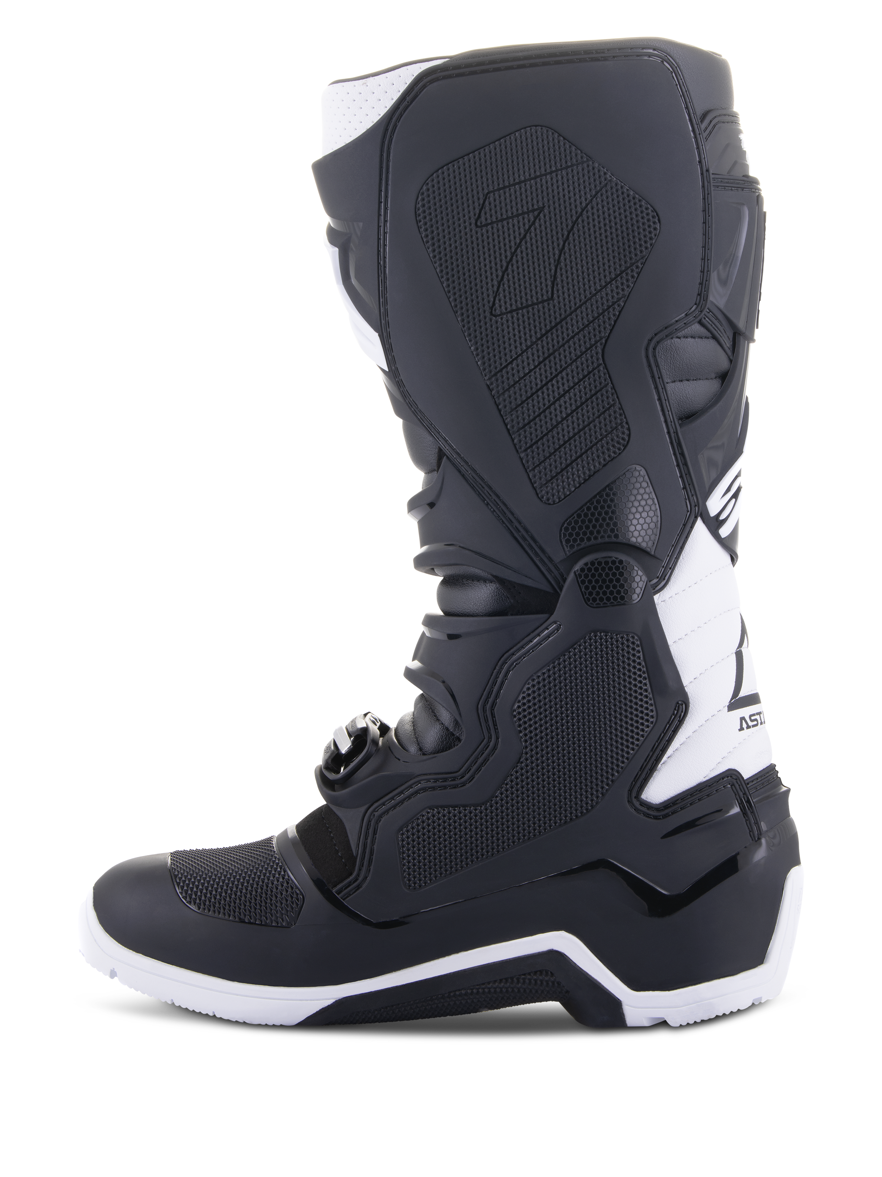Alpinestars Tech 7 Enduro Drystar® Boots, buty motocyklowe enduro, czarno-białe, widok od strony wewnętrznej z panelami o strukturze plastra miodu zapewniającymi przyczepność, konstrukcja TPU oraz białe akcenty na pięcie i górnej części łydki, profesjonalne obuwie terenowe