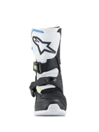 Buty Alpinestars Kids Tech 3S, młodzieżowe buty motocrossowe, białe, czarne i niebieskie, widok z przodu pokazujący płytę goleniową TPU z logo gwiazdy, czarne i białe panele oraz system bezpiecznego zapięcia na klamry