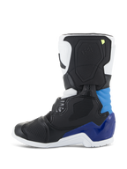 Buty Alpinestars Kids Tech 3S, buty motocrossowe, biało-czarno-niebieskie, profil boczny z czarnymi i białymi panelami oraz intensywnie niebieskimi akcentami na pięcie i kostce, biała podeszwa, strukturalna skorupa ochronna do wyścigów terenowych
