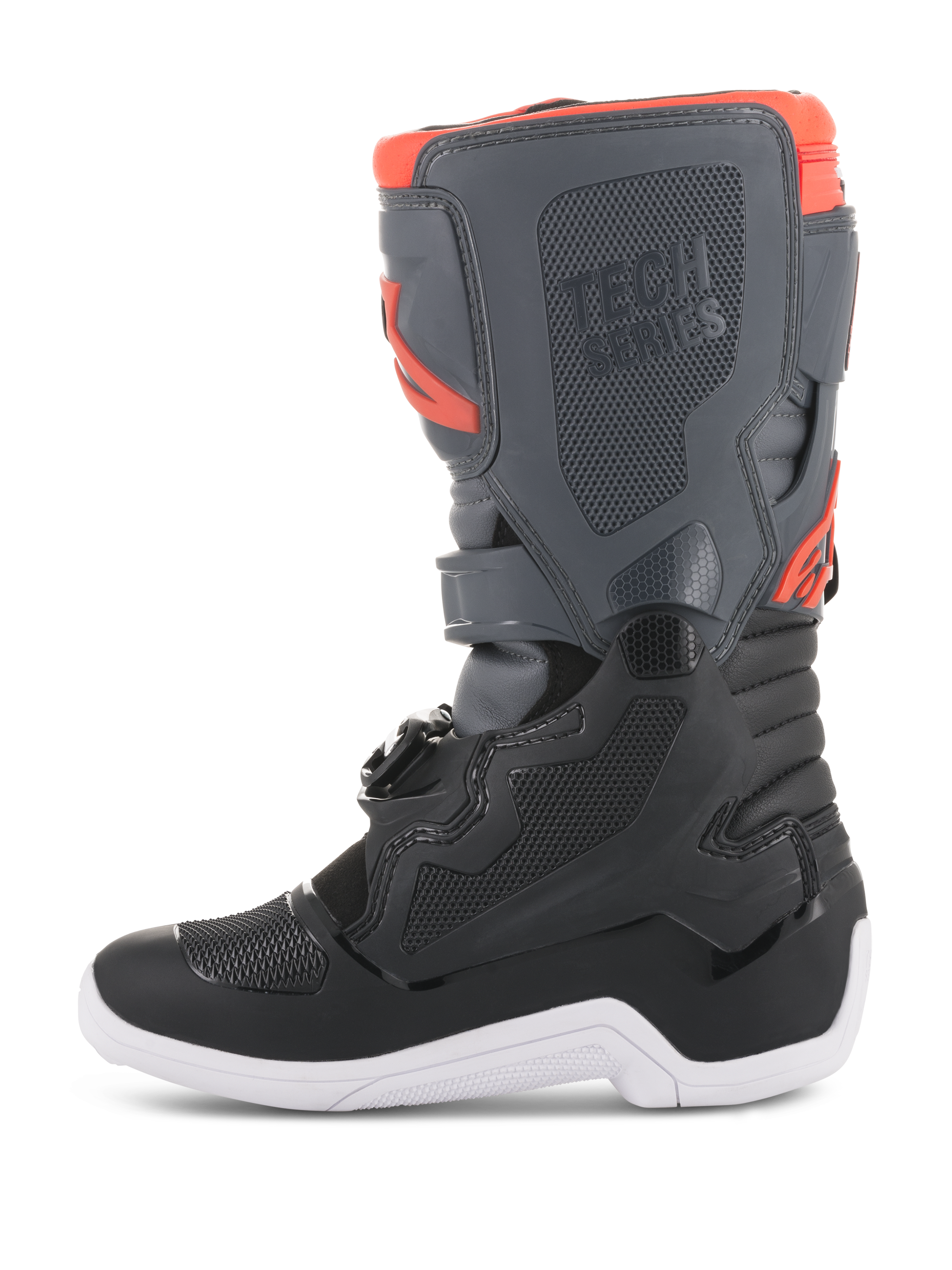 Buty Alpinestars Youth Tech 7S, buty motocrossowe, czarne, ciemnoszare i fluorescencyjne czerwone, widok z boku, ochronne panele TPU, branding Tech Series i biała podeszwa