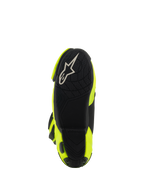 Alpinestars Supertech R Boots, motocyklowe buty wyścigowe, żółte neonowe i czarne, widok od spodu pokazujący czarną teksturowaną podeszwę z białym logo Alpinestars i jaskrawożółte panele boczne