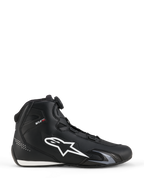 Buty Alpinestars Celer, buty motocyklowe, czarno-białe, profil boczny z dużym białym logo z gwiazdą, system zamykania Rotor z pokrętłem do regulacji dopasowania, smukła sportowa sylwetka