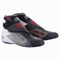 Alpinestars Tech-1 KZ V2, buty kartingowe, czarne, białe i złote z czerwonymi akcentami, bezszwowa dzianinowa cholewka, podwójne zapięcie na rzep, ochronne wzmocnienie palców, złote logo gwiazdy, wysokie wsparcie kostki dla maksymalnej precyzji w kartingu