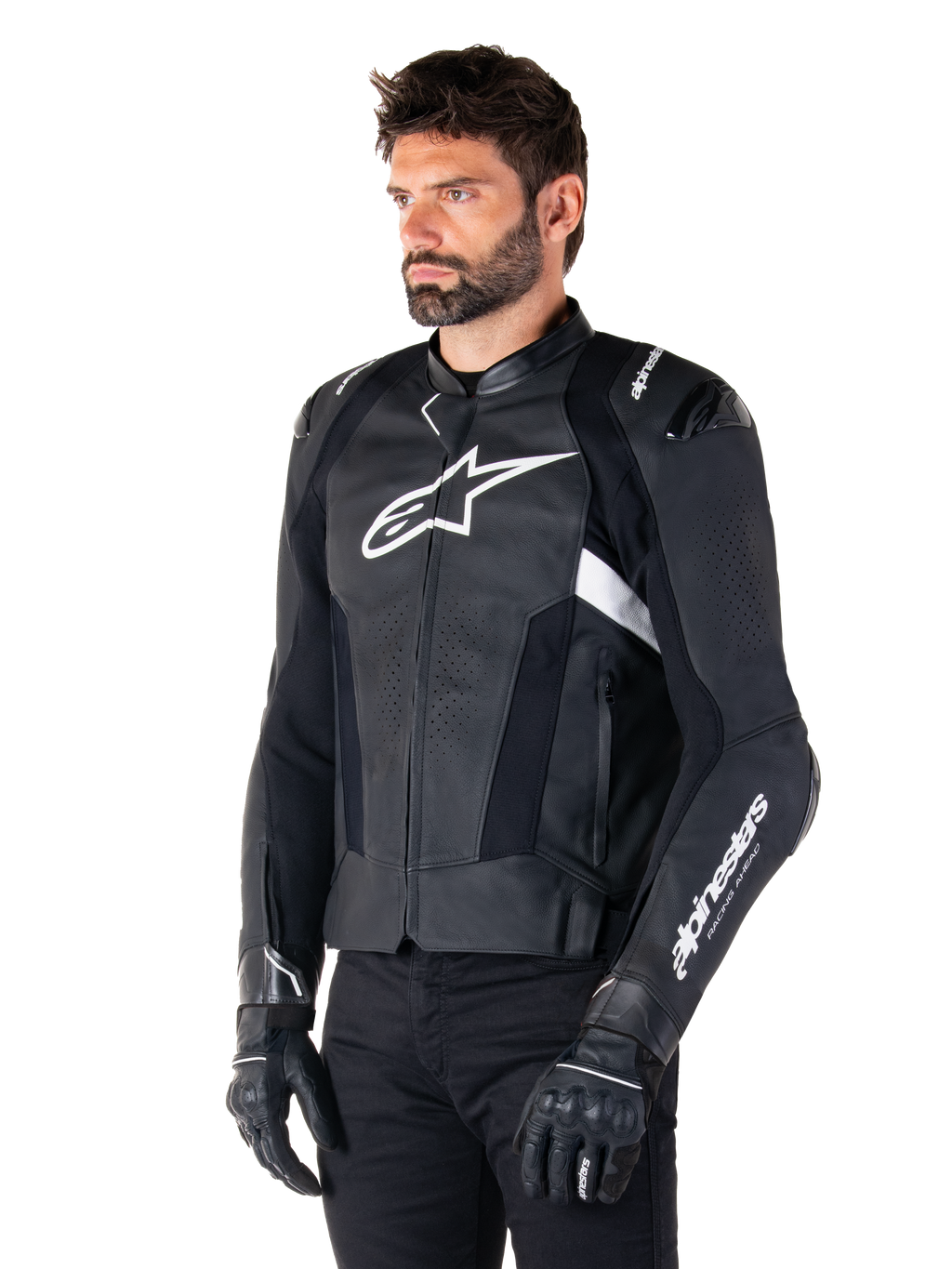 Alpinestars Missile V3 Leather Jacket, Black and White, worn by a man with black riding gloves, featuring a prominent white Alpinestars logo on the chest, external shoulder sliders, and perforated panels for a racing-inspired look.