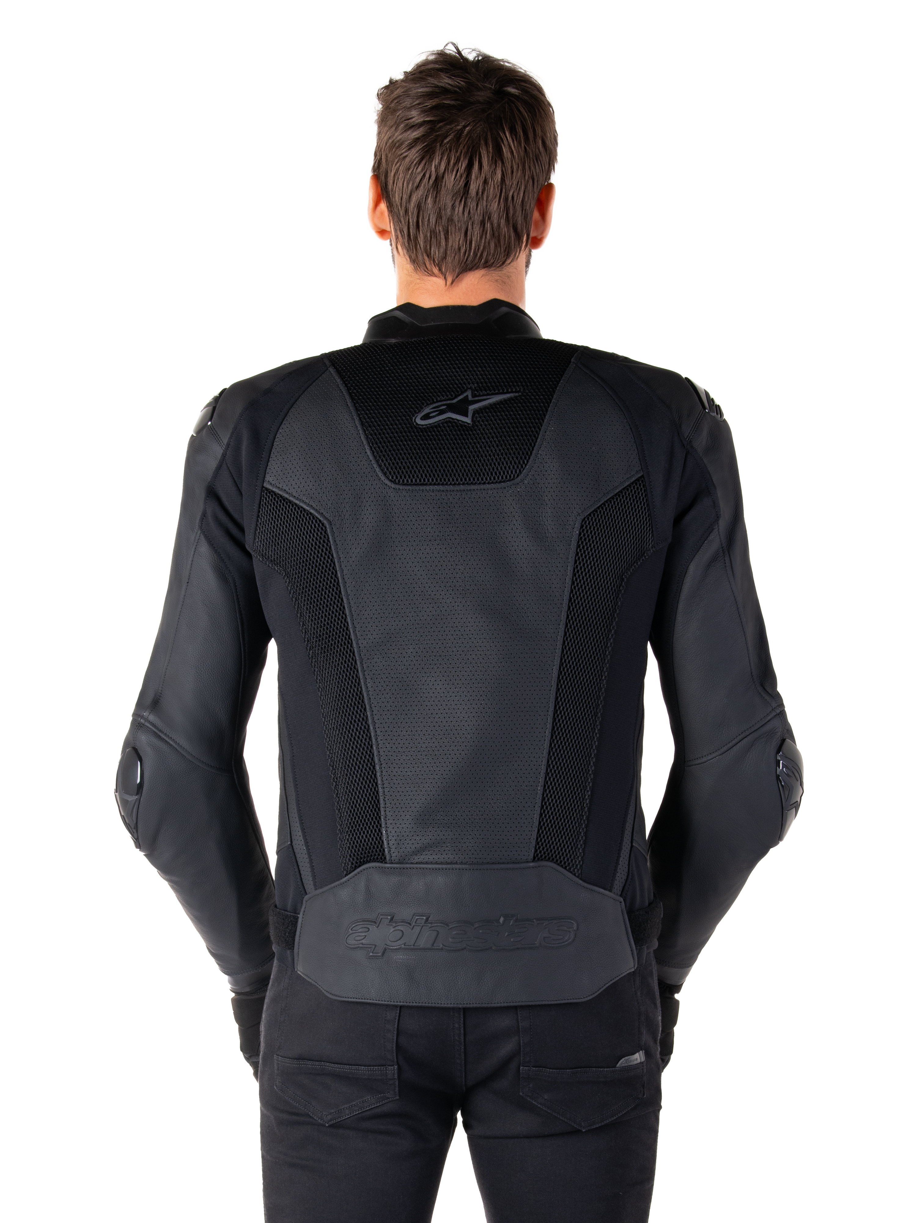 Rear view of a model wearing the Alpinestars Missile V3 Airflow Leather Jacket in Black, showing extensive perforated panels and mesh inserts on the back for ventilation, with embossed branding on the lower back.