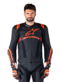 Skórzana kurtka Alpinestars Missile V3 Ignition, wyścigowa kurtka motocyklowa, czarna i czerwona fluo, prezentowana z dopasowanymi rękawicami wyścigowymi i skórzanymi spodniami, z perforowaną wentylacją i widocznym brandingiem Alpinestars, profesjonalna odzież wyścigowa