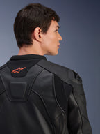 Skórzana kurtka Alpinestars GP Plus R V4 Airflow, czarna, zbliżenie na tył na modelu, widoczna perforowana skóra klasy wyścigowej, techniczne panele elastyczne i małe pomarańczowe logo Alpinestars na kołnierzu, profesjonalna odzież motocyklowa