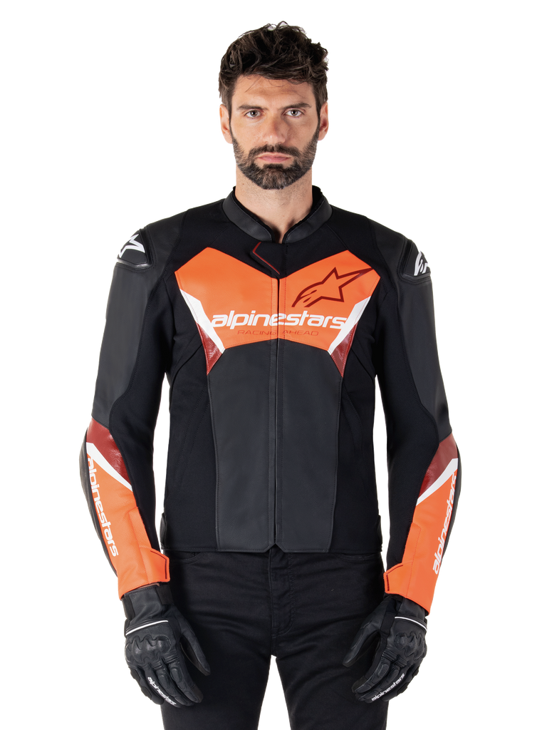 Alpinestars Faster V3 Leather Jacket, Sport Motorcycle Jacket, Black and Red Fluo, worn by a male model with black riding gloves and pants, featuring bold Alpinestars branding on chest and forearms, premium leather construction for road riding.