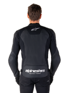 Alpinestars Faster V3 Leather Jacket, Sport Motorcycle Jacket, Black with white branding, rear view worn by model, featuring the Alpinestars logo on the upper back and 'RACING AHEAD' text on the lower back, premium leather construction with ergonomic stretch panels.