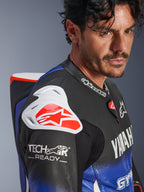 Kombinezon skórzany Yamaha GP-R7 1PC, Metallic Blue Black White Red, zbliżenie na ramię i klatkę piersiową, biały ochraniacz barku DFS z czerwonym logo, garb aerodynamiczny oraz oznaczenie Tech-Air Ready na perforowanym skórzanym rękawie.