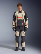 Alpinestars Halo Pro Drystar® XF Laminated Jacket, Mastic Black, adventure motorcycle jacket worn by a model with matching pants and gloves, tan and black textile panels with bold red logos, modular design for all-terrain riding
