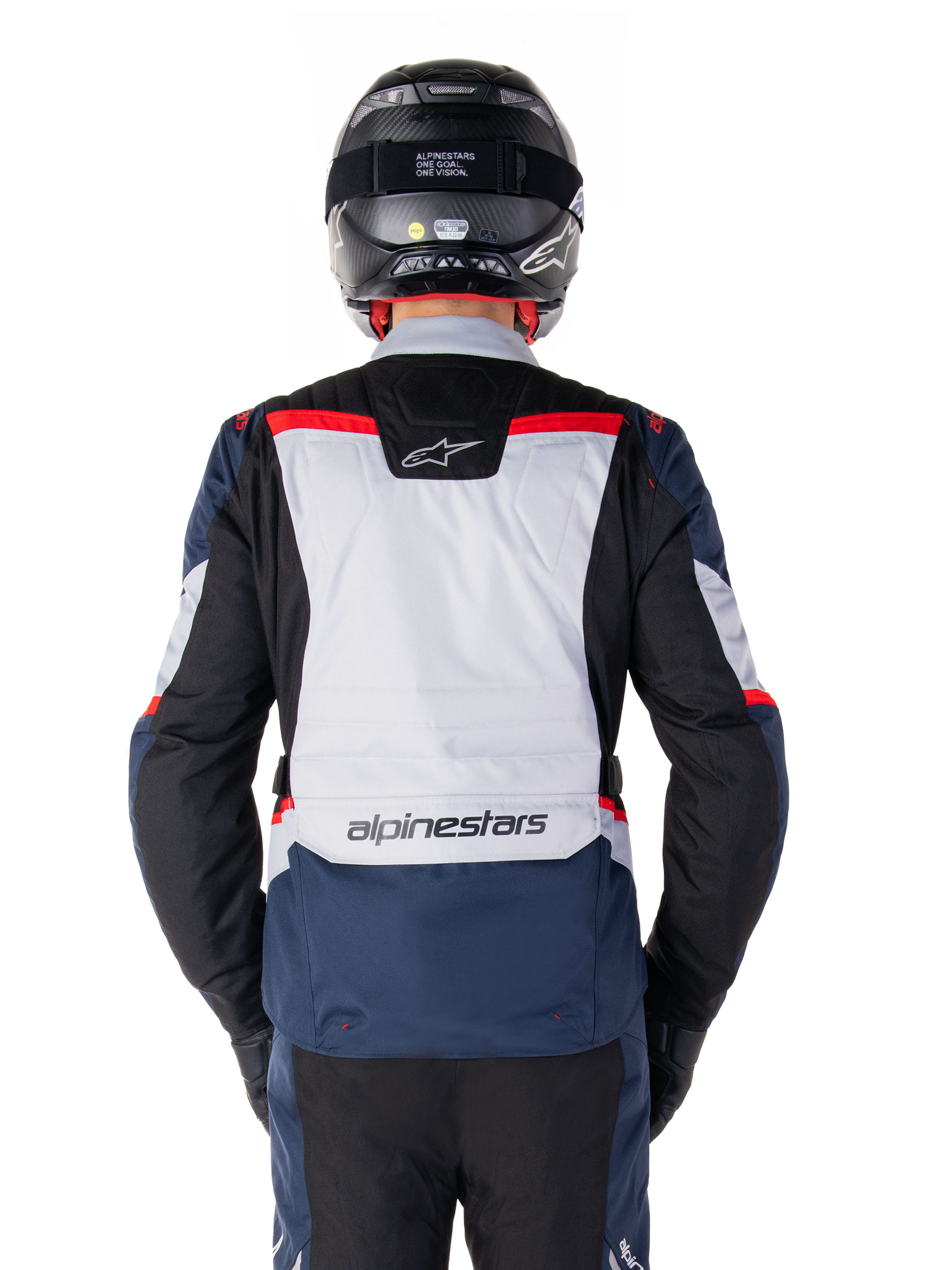 Alpinestars ST-1 Waterproof Jacket, Dark Blue Black and Bright Red, rear view showing light gray back panel and branding, adventure touring motorcycle jacket worn with black helmet and gloves, streamlined design for all-weather riding