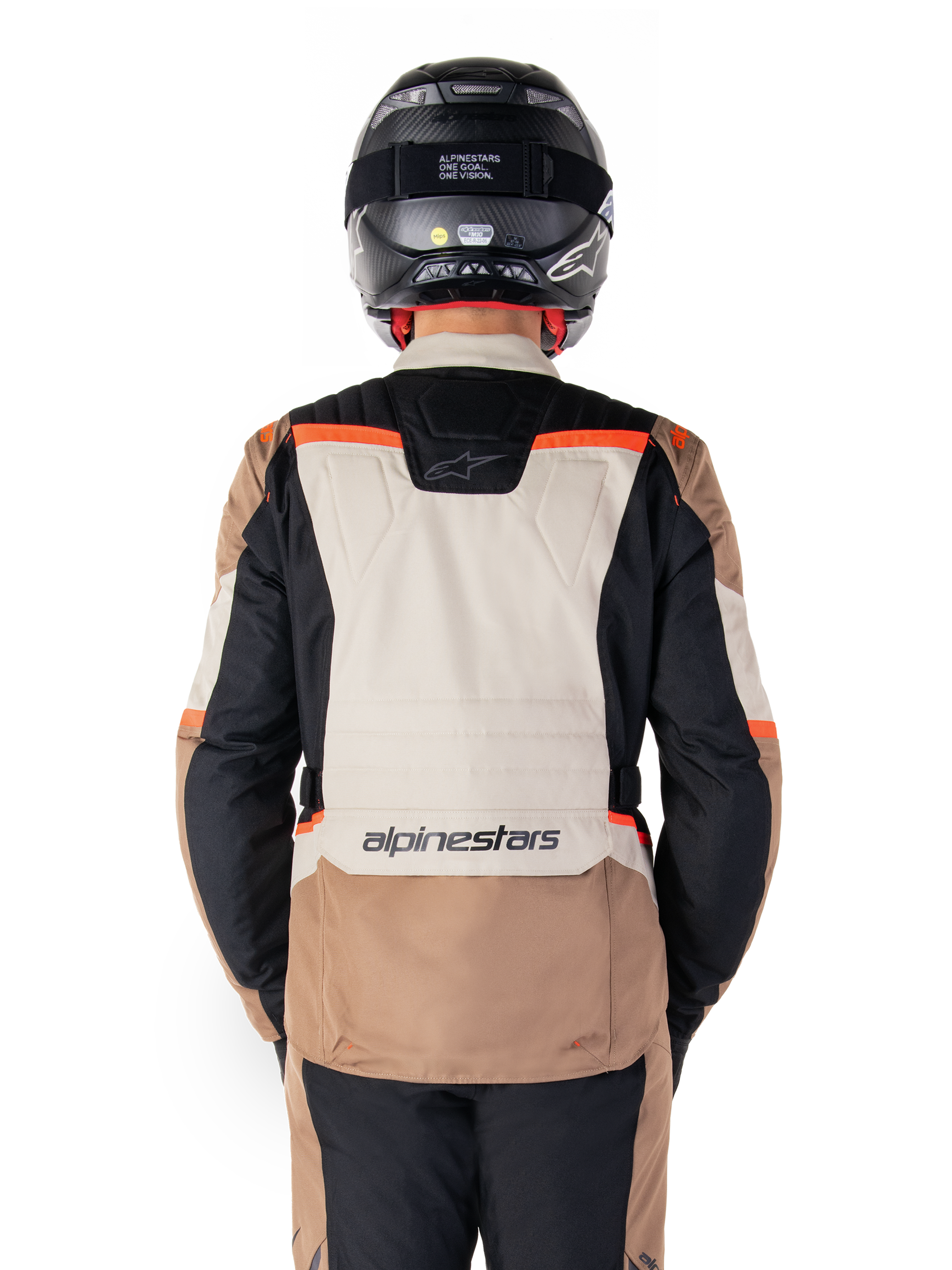 Alpinestars ST-1 Waterproof Jacket, Dark Khaki Sand Black Red Fluo, Rear view, adventure touring motorcycle jacket featuring a large sand-colored back panel, black sleeves, and red fluorescent accents, shown on a rider with a black helmet.