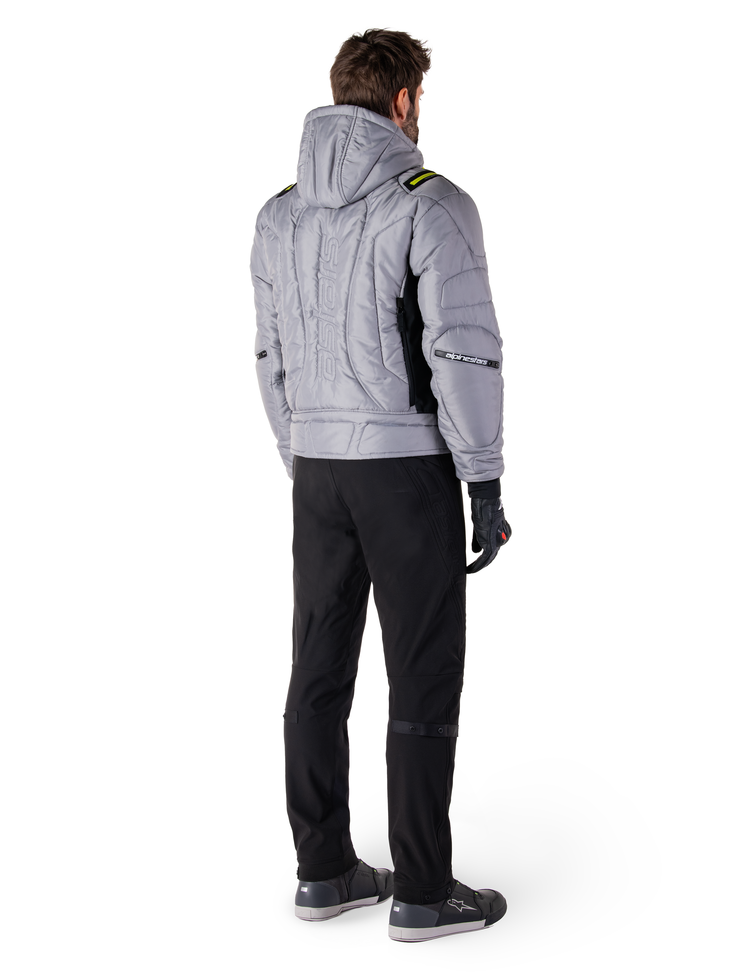 Alpinestars Mohobbs Waterproof Jacket, Lunar Gray Lime Punch, rear view of quilted bomber-style motorcycle jacket with hood, featuring Alpinestars wordmark on back, worn with black riding pants and gloves, urban moto streetwear