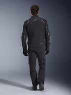 Alpinestars Andes Pro Drystar® XF Jacket, adventure touring jacket, Black and Dark Gray, rear view showing large cargo pocket and reinforced elbow panels, worn with matching black pants and gloves, sleek functional design for all-weather riding