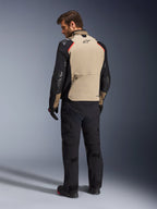 Kurtka Alpinestars Andes Pro Drystar® XF, kurtka motocyklowa, orzechowo-czarna z czerwonymi akcentami, widok z tyłu na modelu, design adventure touring z dużą tylną kieszenią, noszona z czarnymi spodniami i rękawicami motocyklowymi