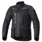 Alpinestars Bogota Pro Drystar Jacket, czarna turystyczna kurtka motocyklowa, szare i czerwone akcenty, duże panele wentylacyjne na klatce piersiowej, wodoodporne kieszenie z czerwonymi uchwytami zamków, wysoki kołnierz ochronny, trwała tekstylna konstrukcja do jazdy typu adventure