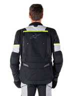 Alpinestars Bogota' Pro Drystar® Jacket, Adventure Touring Motorcycle Jacket, Black Ice Gray and Yellow Fluo, rear view showing 'TECH TOURING' branding on a fluorescent yellow stripe, large back ventilation panel, and adjustable waist straps, technical all-season gear