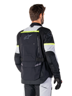 Alpinestars Bogota' Pro Drystar® Jacket, adventure touring jacket, Black Ice Gray and Yellow Fluo, rear view featuring large back pocket panel with 'TECH TOURING' branding, Alpinestars logo, and fluorescent accents, technical textile riding gear