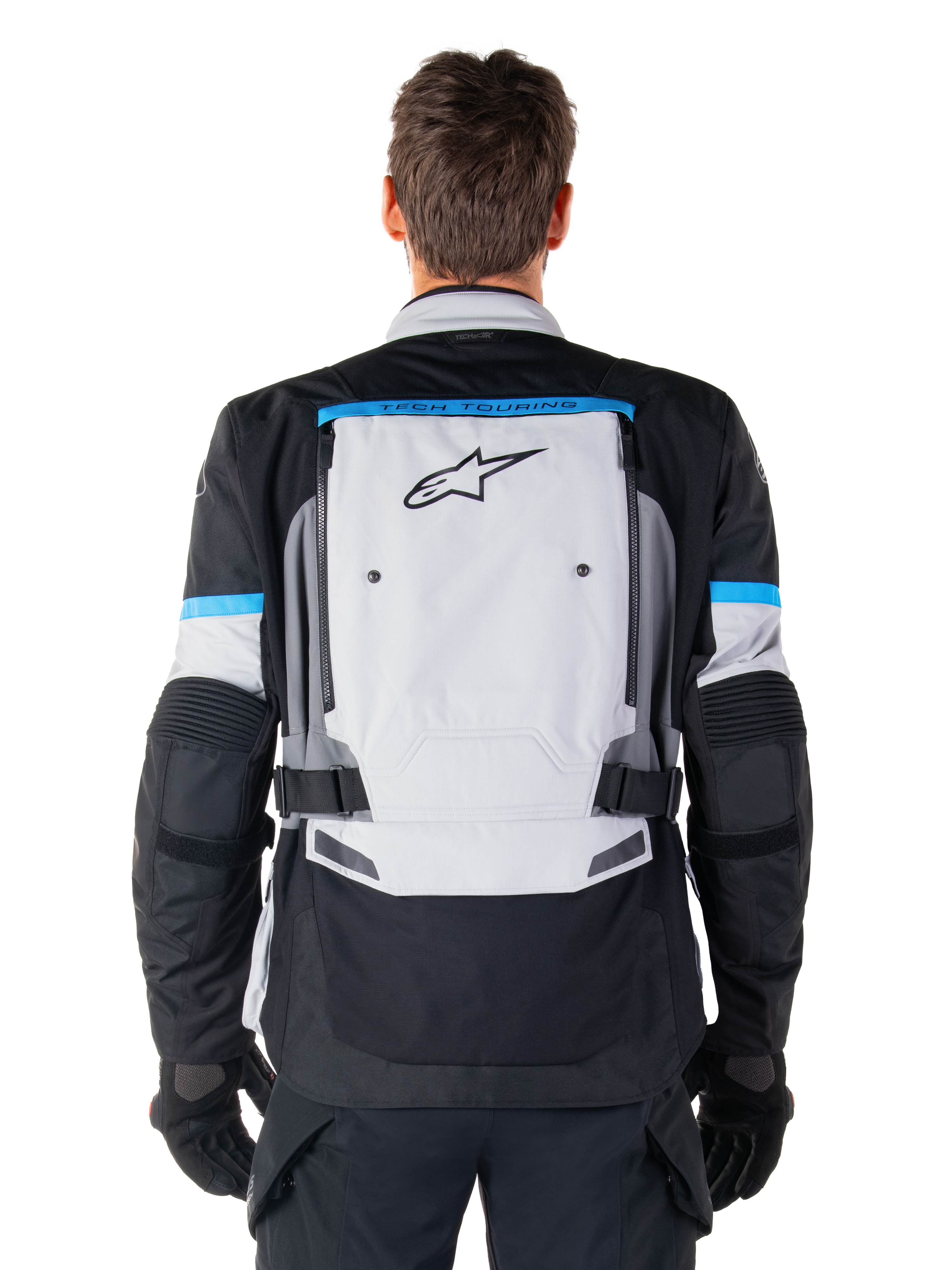 Kurtka Alpinestars Bogotá Pro Drystar®, motocyklowa kurtka adventure, kolor Ice Gray, czarny i cyjanowy, widok z tyłu przedstawiający duży jasnoszary panel z czarnym logo gwiazdy, cyjanowe akcenty z brandingiem Tech Touring oraz regulowane paski w talii