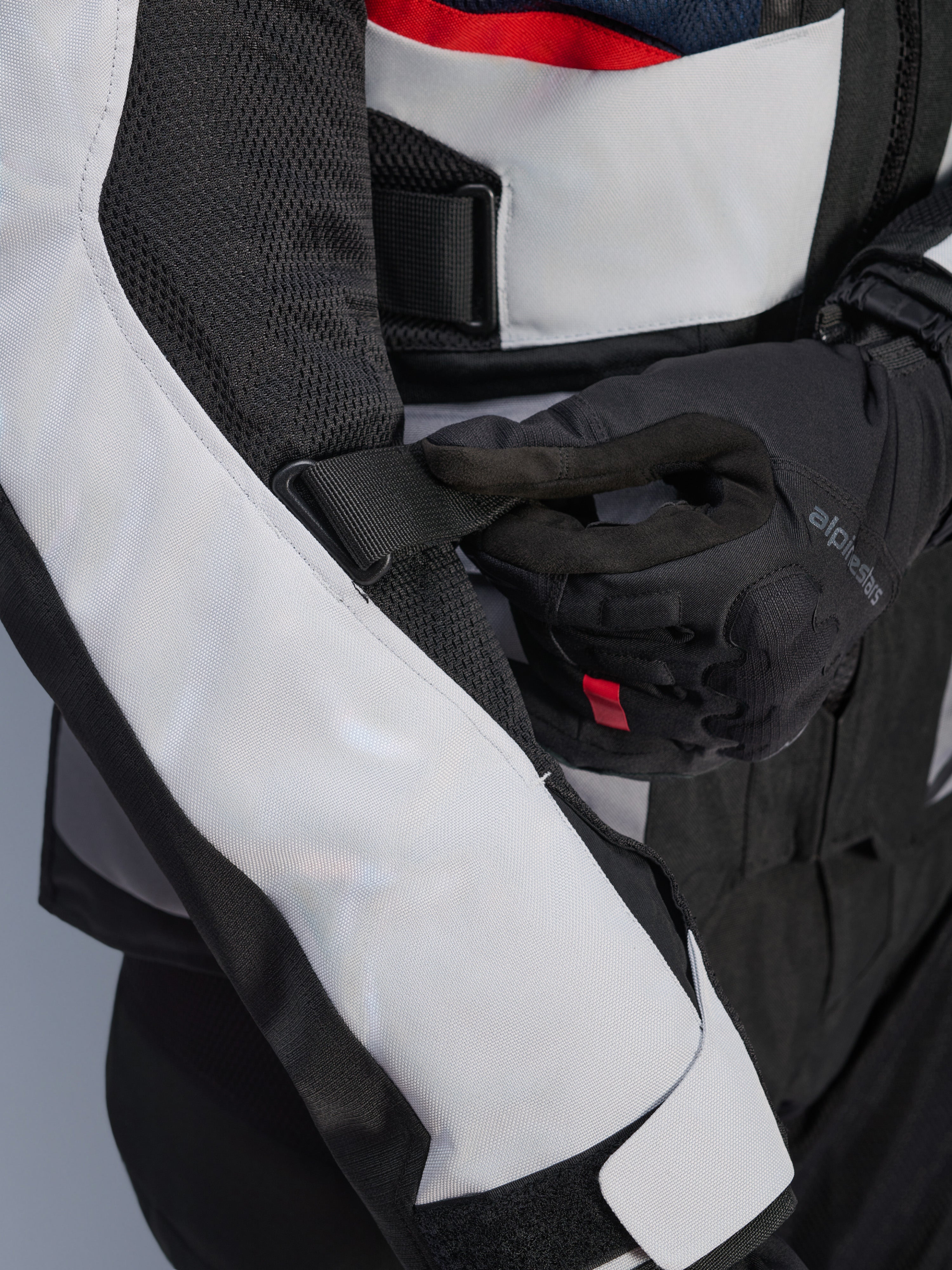 Alpinestars Andes Air Drystar® Jacket w kolorze Deep Blue Black Ice Gray, zbliżenie na regulowany pasek na rękawie i siatkowe panele wentylacyjne, wytrzymała konstrukcja tekstylna do turystyki przygodowej