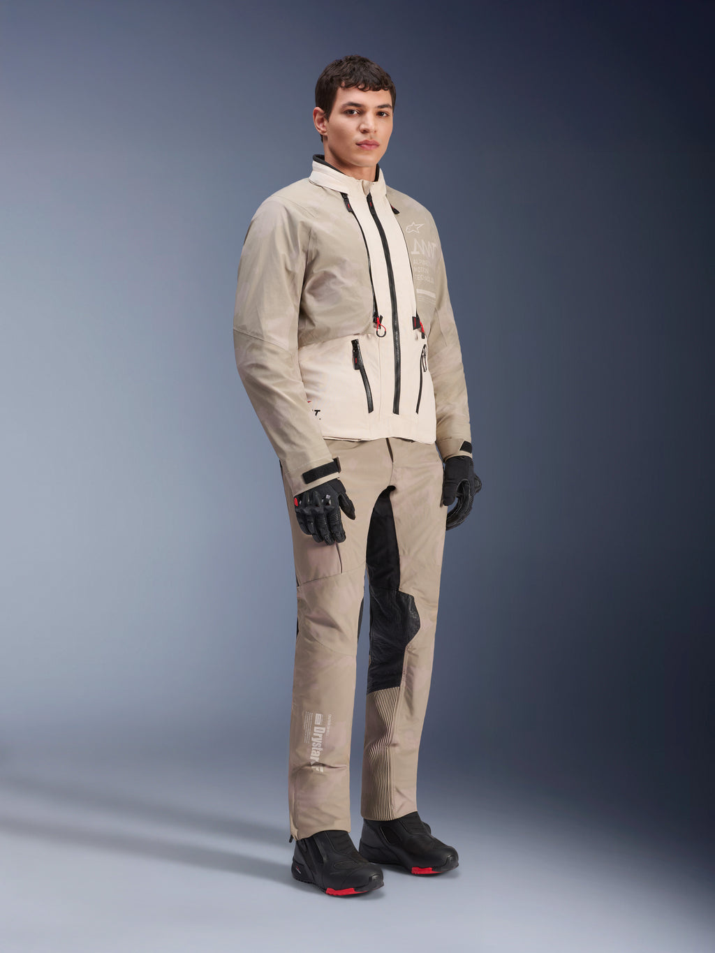 Alpinestars AMT-10LAB Drystar® XF Jacket, Adventure Motorcycle Jacket, White Sand Aluminum Camo, worn with matching adventure pants, black motorcycle gloves and boots, full-body studio shot, multi-season protective riding gear