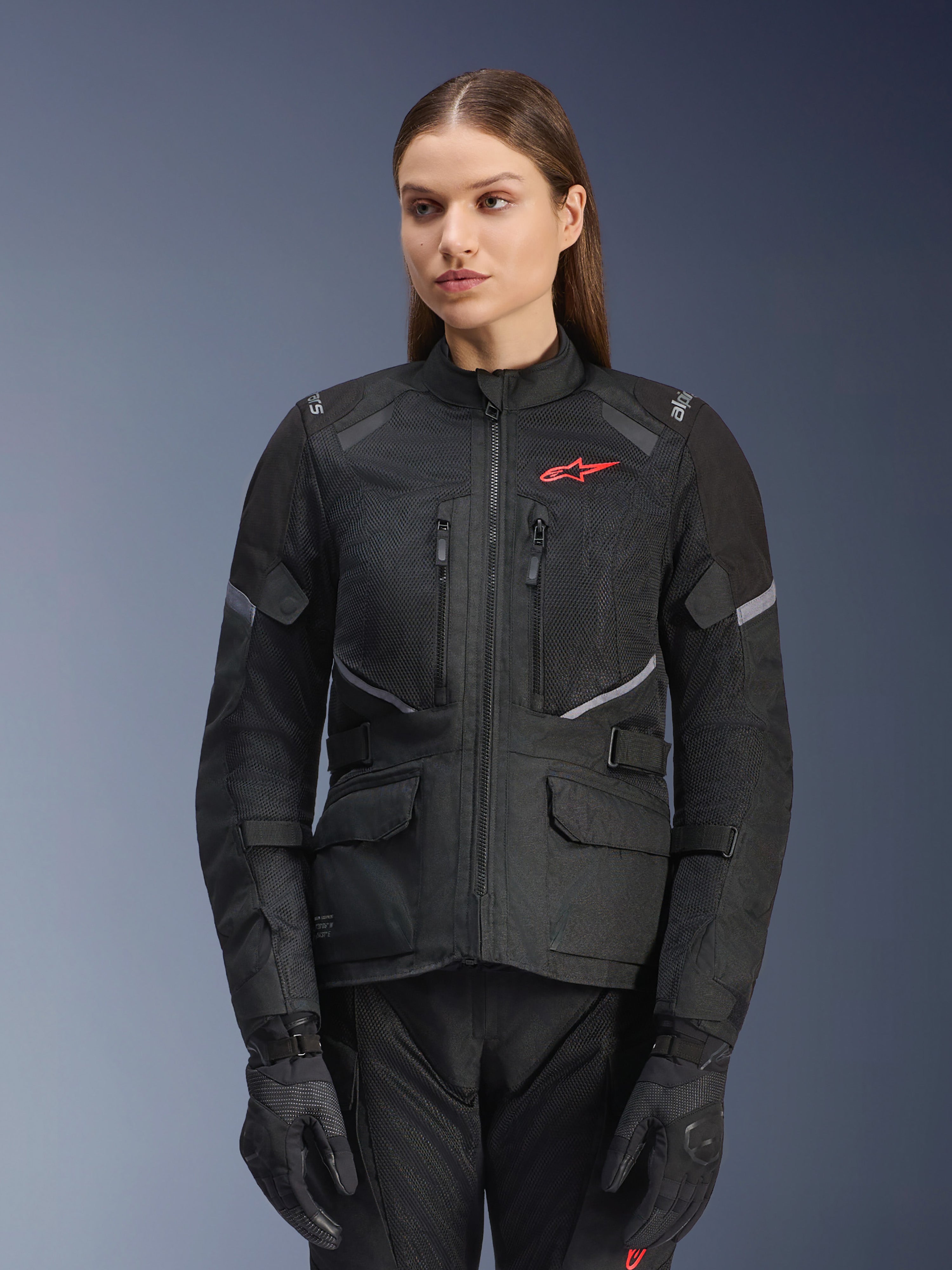 Kurtka Alpinestars Stella Andes Air Drystar, damska kurtka motocyklowa turystyczna, czarna z szarymi akcentami i małym czerwonym logo, z siatkowymi panelami wentylacyjnymi, wysokim kołnierzem i wieloma praktycznymi kieszeniami, noszona wraz z pasującymi rękawicami i spodniami motocyklowymi