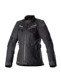Alpinestars Women Stella Bogota Pro Drystar Jacket, Black adventure touring motorcycle jacket, waterproof textile construction with multiple front zippers and ventilation panels, adjustable straps on sleeves and waist, subtle red accents and Alpinestars branding.