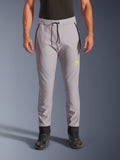 Alpinestars Aeroshell Pants, motocyklowe spodnie softshellowe typu crossover, szare i jaskrawożółte, czarny sznurek w pasie i dopasowane ściągacze przy kostkach, żółte logo na lewym udzie, profilowane kolana, sportowa sylwetka typu jogger