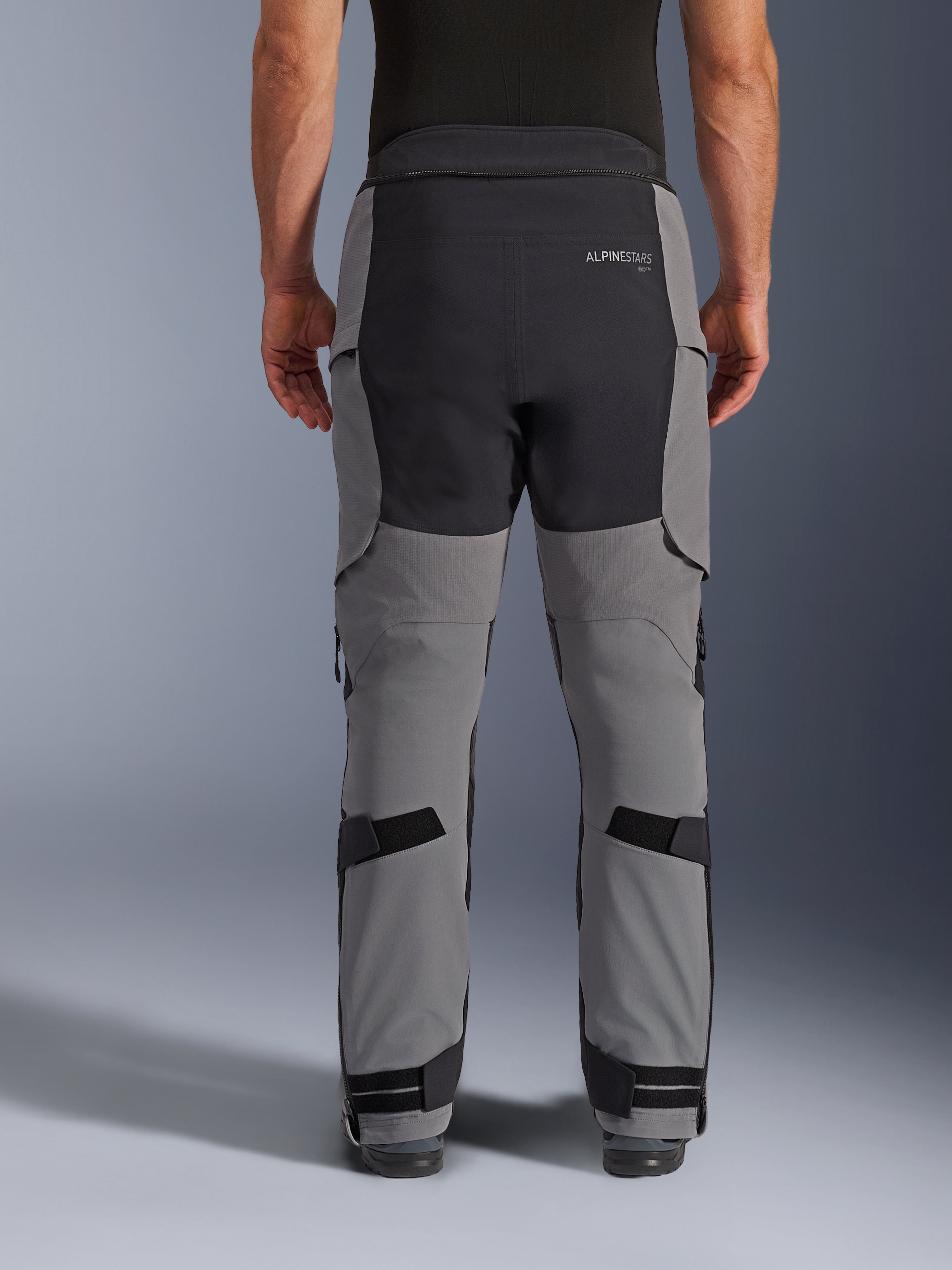 Alpinestars Andes Pro Drystar® XF Pants, Adventure Motorcycle Pants, Dark Gray and Black, back view highlighting black seat panel with logo, adjustable straps on the calves and ankles, rugged technical design for adventure touring.