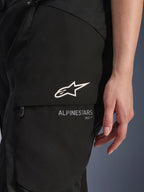 Alpinestars Stella Andes V4 Drystar® Pants, Women's Motorcycle Pants, Black, close-up of thigh cargo pocket with white star logo and branding, durable textile material for adventure touring