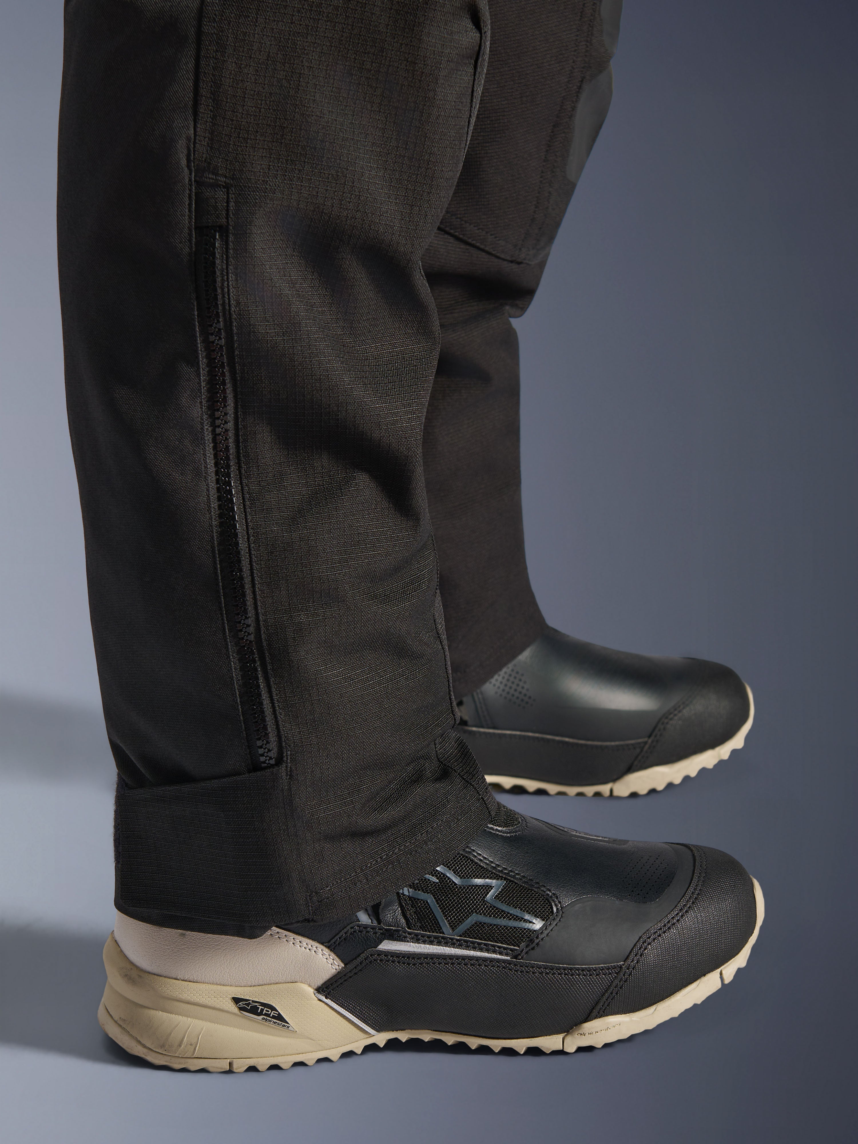 Alpinestars Stella Andes V4 Drystar® Pants, Black lower leg detail showing vertical side zipper for boot fitment, durable textile fabric construction, adventure motorcycle riding gear for women.