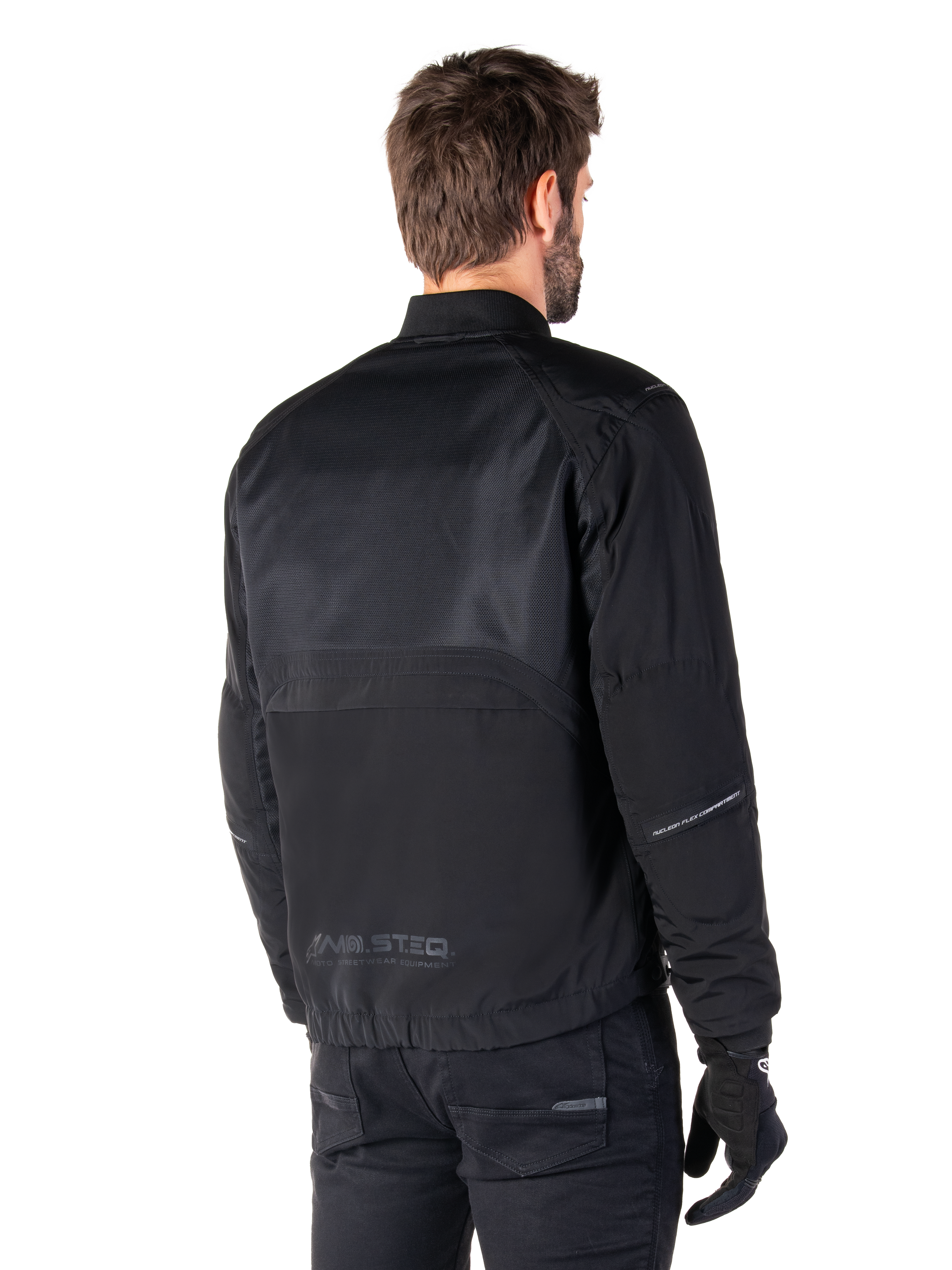 Alpinestars Mootant Waterproof Parka, Black motorcycle jacket, rear view, featuring mesh upper panels and MO.ST.EQ. Moto Streetwear Equipment branding, urban contemporary design for road riding