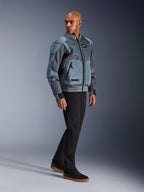 Alpinestars Flight Air Jacket, Storm Gray, Urban Bomber-inspired Motorcycle Jacket, worn by a male model with black pants and sneakers, featuring extended 3D mesh ventilation panels and external protector pockets, modern streetwear protective gear for hot weather riding