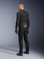 Kurtka Alpinestars Viper Air V4, czarna tekstylna kurtka motocyklowa, widok z tyłu na męskim modelu, duże panele z siatki technologicznej dla optymalnego przepływu powietrza, białe logo gwiazdy na dole pleców, noszona z czarnymi spodniami i rękawicami motocyklowymi