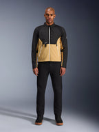 Kurtka Alpinestars Provoke w kolorze Black Camel, miejska kurtka motocyklowa o dwukolorowym czarno-karmelowym designie, prezentowana na modelu w czarnych spodniach i butach, nowoczesna sylwetka z białymi zamkami i techniczną konstrukcją softshell
