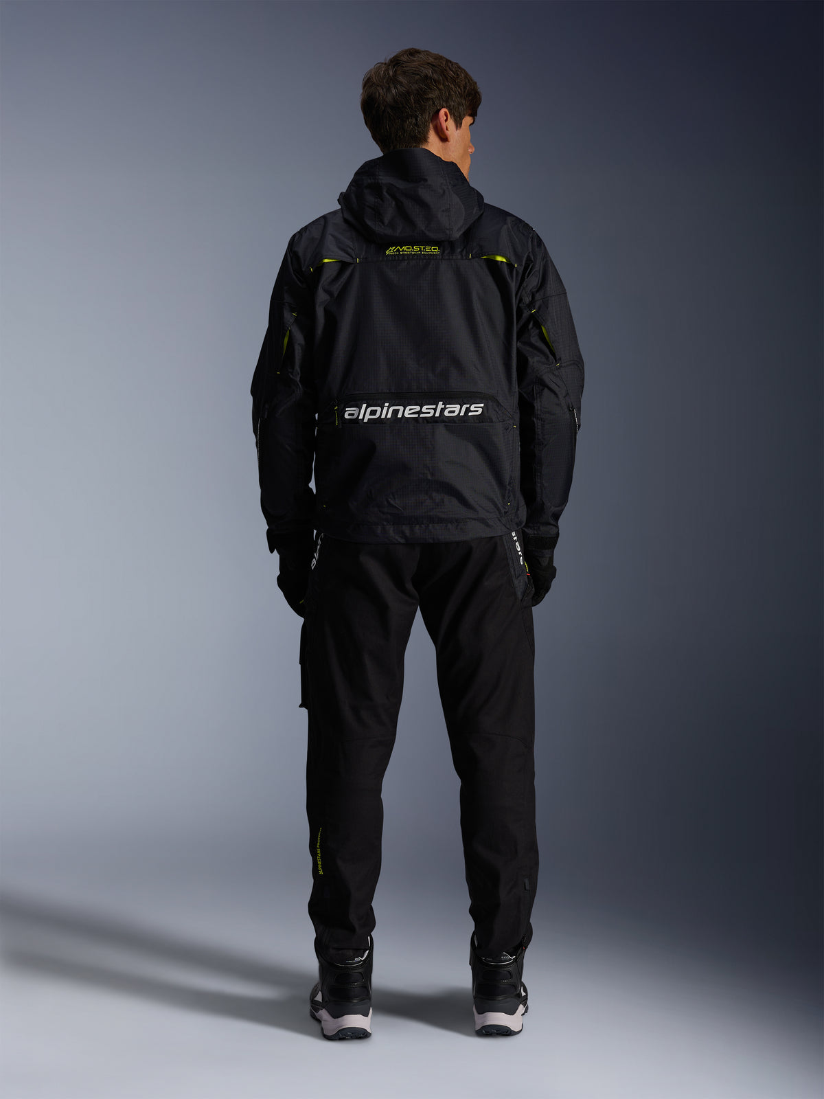 Alpinestars Mogress Air, miejska tekstylna kurtka motocyklowa, czarna i limonkowa, widok z tyłu, białe logo