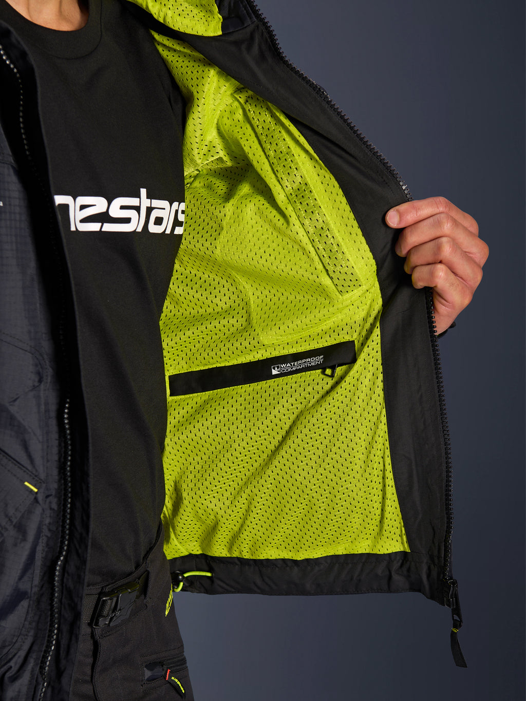 Kurtka Alpinestars Mogress Air, detale wnętrza z jaskrawą, limonkową podszewką z siateczki i czarną wodoodporną kieszenią wewnętrzną, funkcjonalny design miejskiej odzieży motocyklowej